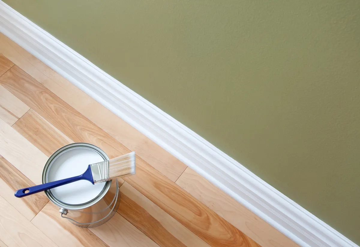 Paint can and baseboard