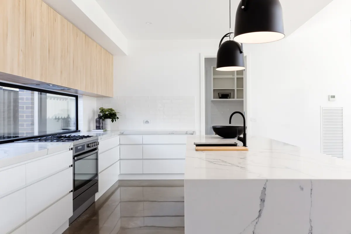 White kitchen with marble island